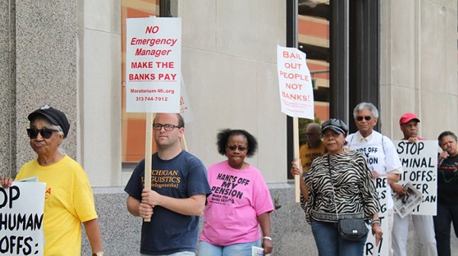 A coalition of activists protests outside the Detroit Water & Sewerage Department’s office in downtown Detroit on Friday, June 6, 2014.