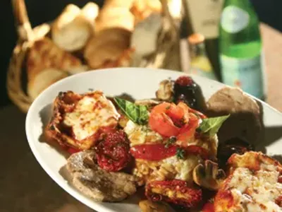 A three item combination: Eggplant, risotto Milanese with mushroom sause and veal Pomodoro, served with housemade bread.