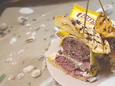 Michael’s corned beef, pastrami, cole slaw, Russian dressing and Swiss cheese on an onion roll, from Parrot Cove.