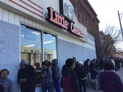 A line stretches down the street outside of Little Caesars in Highland Park during the Monday lunch hour.