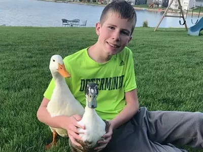 Dylan with his emotional support ducks, Nibbles and Bill.