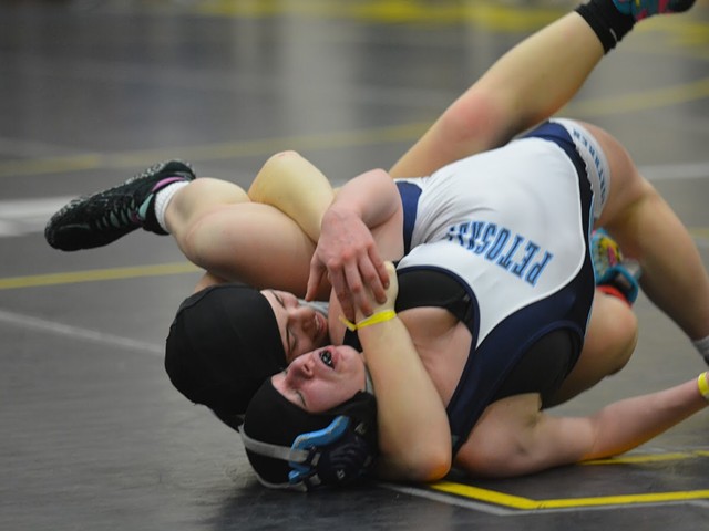 Cutline: Fenton High School senior Chloe Wagner tries to pin Petoskey's Lydia Krauss in the 140-pound final at the first-ever Michigan Wrestling Association girls state championship on Sunday, Feb. 3 at Adrian College.