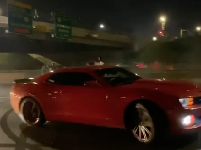 Red Camaro blows donuts on I-94.