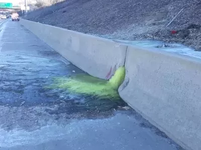 Green liquid oozing from retaining wall along I-696.