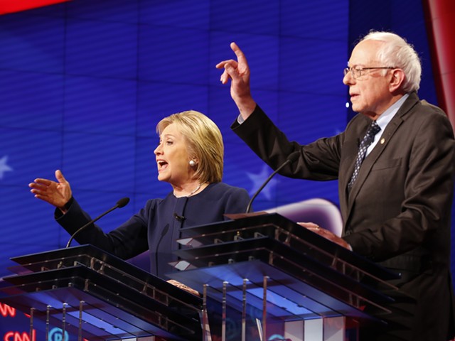Former Secretary of State Hillary Clinton, left, and Vermont Sen. Bernie Sanders during Sunday's Democratic presidential debate at The Whiting Auditorium in Flint.