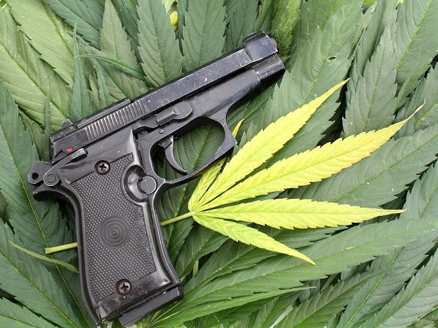 On the federal level, marijuana is still illegal, and it's a felony punishable by up to 10 years in prison to smoke pot and buy or own a gun.