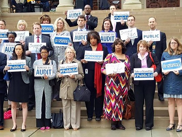 Michigan representatives who want an audit of DPS stand on the steps of the state Capitol.