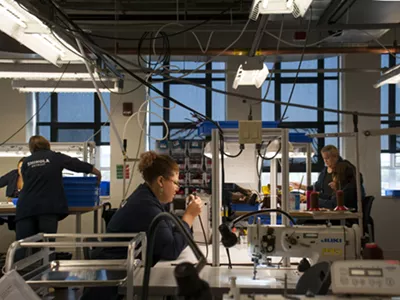 Employees at Shinola's New Center leather factory, located in a former GM design lab.