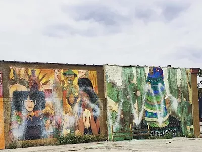 The mural was apparently defaced with white spray paint.