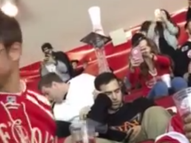 VIDEO: These Red Wings fans made an epic cup tower on a sleeping fan's head