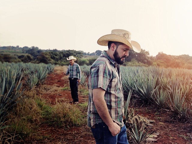Antonio Lopez with his father, Silverio, in the background on their agave farm in the Los Altos region in the Mexican state.
