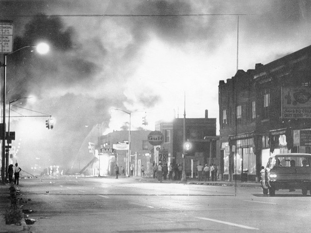 Fire from burning buildings light up the night sky on Detroit's west side.