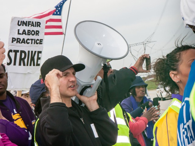 Striking workers and supporters from an Illinois Walmart distribution center march against unfair labor practices, including wage theft, in 2012.