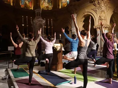 Yogis in tree pose during a Ignatian Yoga flow.