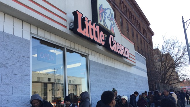 A line stretches down the street outside of Little Caesars in Highland Park during the Monday lunch hour.