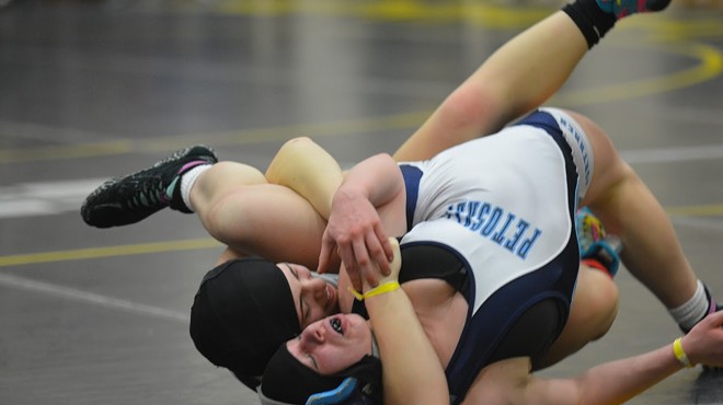 Cutline: Fenton High School senior Chloe Wagner tries to pin Petoskey's Lydia Krauss in the 140-pound final at the first-ever Michigan Wrestling Association girls state championship on Sunday, Feb. 3 at Adrian College.