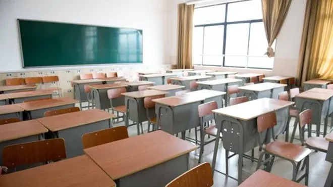 No, it's not a DPS classroom; it's stock art. How can you tell? No mushrooms growing in wall, clearly fewer than 30 desks, and lack of rags stuffed in broken windows to keep out breeze.