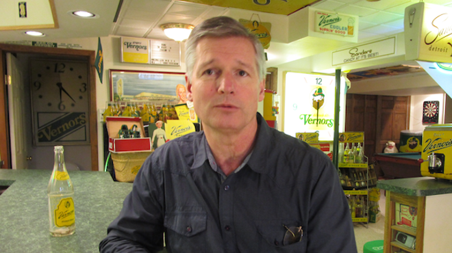 Keith Wunderlich sits at the soda fountain in the small museum he's built in his basement.