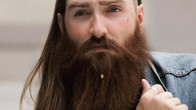 A hipster with beard jewelry. Sadly, this is not a joke.