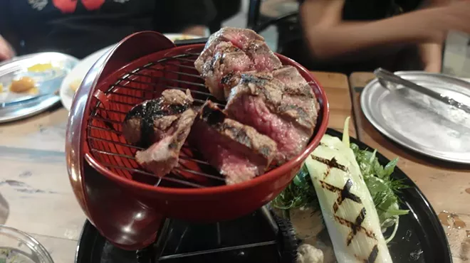 The "High Steaks" is served in a mini Weber grill replica and a side of "Willie Nelson Tater Salad."