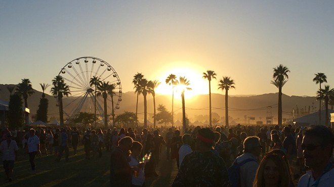 The sun sets over the Desert Trip festival in Indio, Calif.