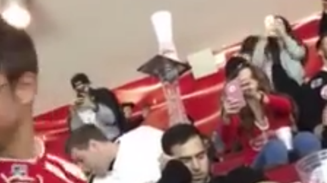 VIDEO: These Red Wings fans made an epic cup tower on a sleeping fan's head
