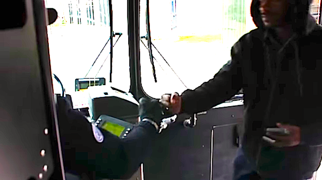 DDOT bus driver Larry Dennis Starkey greets a passenger boarding the 53 Woodward bus.