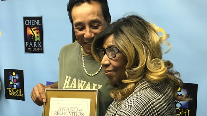 Aretha Franklin presents a City of Detroit Award of Recognition to Smokey Robinson before his performance at Chene Park Amphitheater.