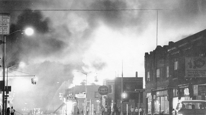 Fire from burning buildings light up the night sky on Detroit's west side.