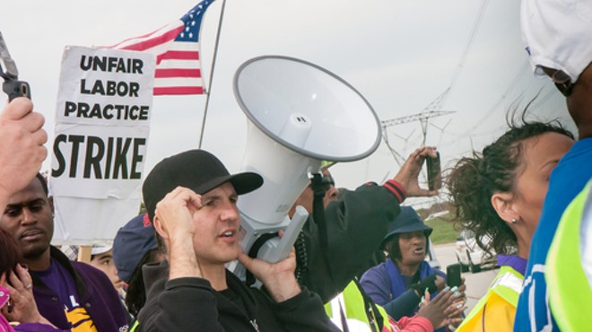 Striking workers and supporters from an Illinois Walmart distribution center march against unfair labor practices, including wage theft, in 2012.