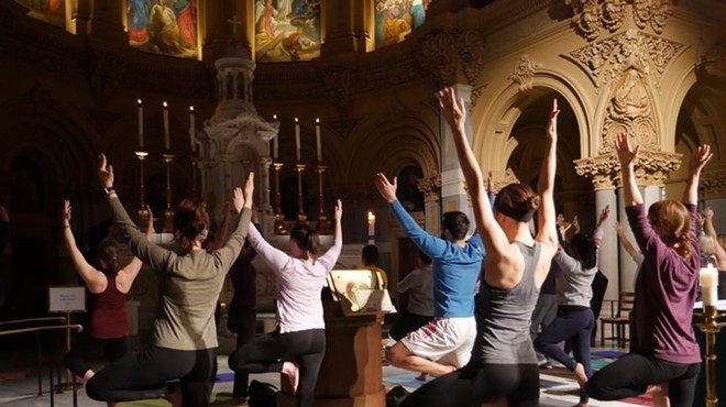Yogis in tree pose during a Ignatian Yoga flow.