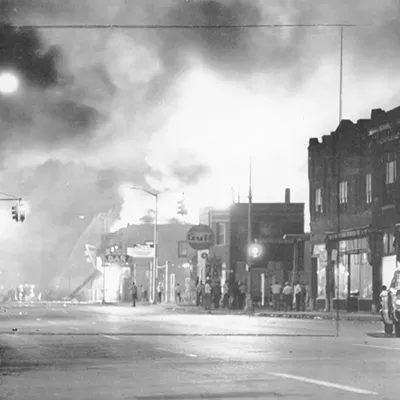 Fire from burning buildings light up the night sky on Detroit's west side.
