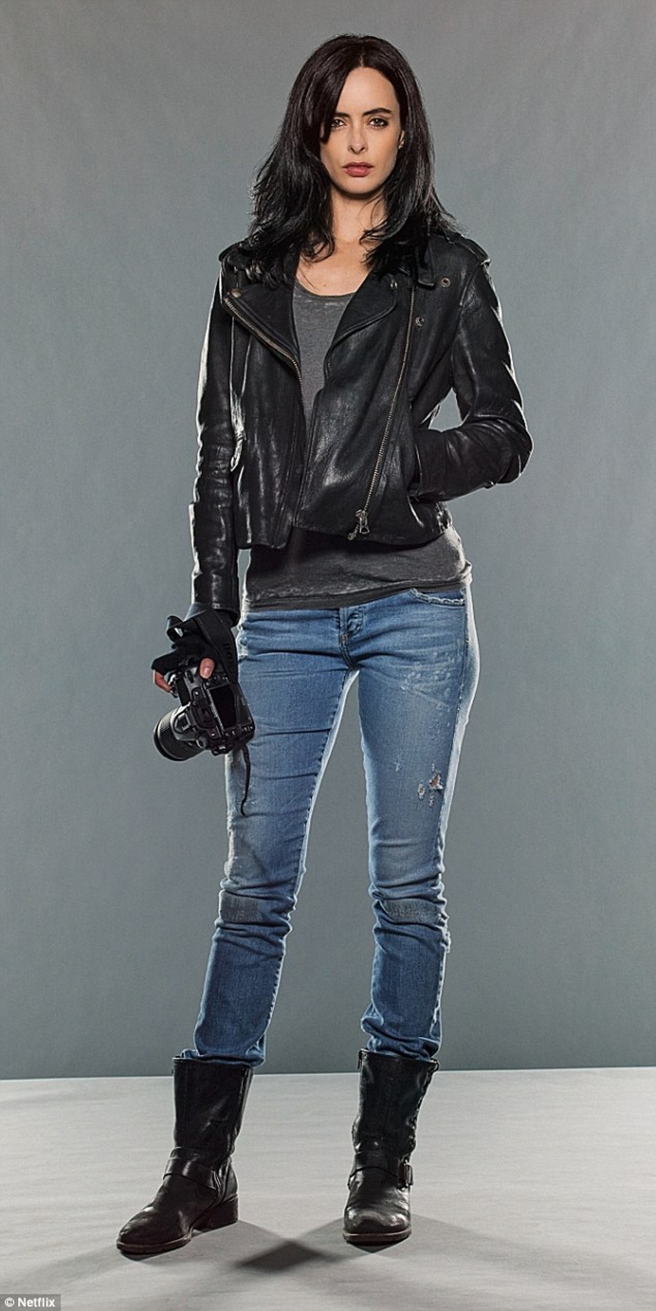 To Be Jessica Jones from the hit Netflix series  Jessica Jones you need a leather jacket, grey shirt, black boots, and blue jeans.( Bonus points for the camera.) 
Photo courtesy of Netflix 