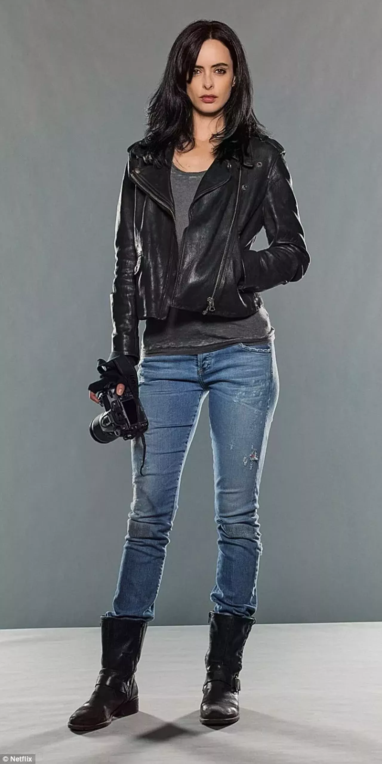 To Be Jessica Jones from the hit Netflix series Jessica Jones you need a leather jacket, grey shirt, black boots, and blue jeans.( Bonus points for the camera.) Photo courtesy of Netflix 