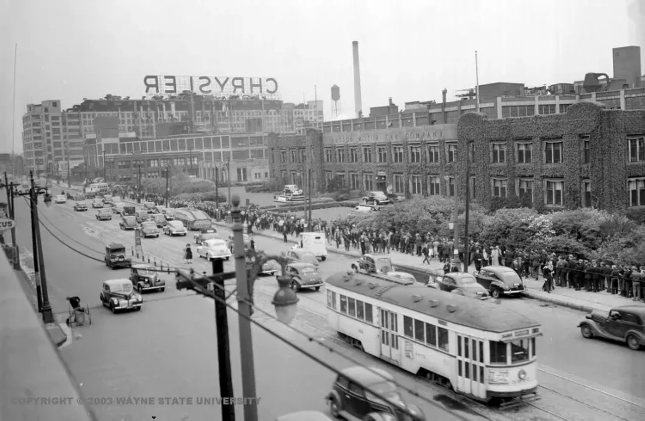 1941 - Hudson Motor Car Company in Detroit Just a view of the everyday commute to work. Trolley cars, mobs of people, cars, quite the scene for workers at the Hudson Motor Car Company and their neighbors at Chrysler.