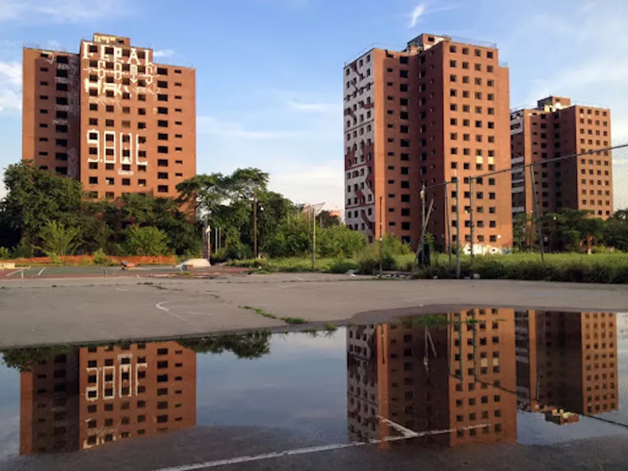 Lost River (2014) Brewster Douglass Projects 2700 St. Antoine St., Detroit There are movies, and then there are movies that are so poorly received that a film critic might describe it as being "colossally indulgent, shapeless, often fantastically and unthinkingly offensive and at all times insufferably conceited." Woof. Well, Ryan Gosling thought he had a real winner on his hands when he wrote, co-produced, and directed Lost River, which, more than any movie ever, truly exploited, er, highlighted all of Detroit's beauty, vacancy, and blight. A fantastical drama, Lost River concerns a secret underwater town and cast of characters who are lost in their own dilapidated worlds, including Christina Hendricks, Saoirse Ronan, and the film's lead, Bones, played by Iain De Caestecker. The film used the backdrop of the historic Brewster-Douglass Projects, which were controversially demolished the same year of Lost River's release. Gosling even said he felt a sense of urgency while filming as to capture a crumbling Detroit. Though the towers may no longer be standing and, as of 2019, the Brewster-Douglass Projects site was purchased by Dan Gilbert's Bedrock for $23 million for mixed-use development, the site holds a lot of emotions for native Detroiters and is worth visiting, studying up on, and paying tribute to our abandoned working class. The real question is: is Lost River worth watching? Honestly, we think so. Considering the whole damn thing was filmed here, though not using many discernable or recognizable locations, it captured Detroit in a way that few films have, for better or worse. Plus, the stunning cinematography distracts from the lack of plot. Photo by Steve Neavling/i>