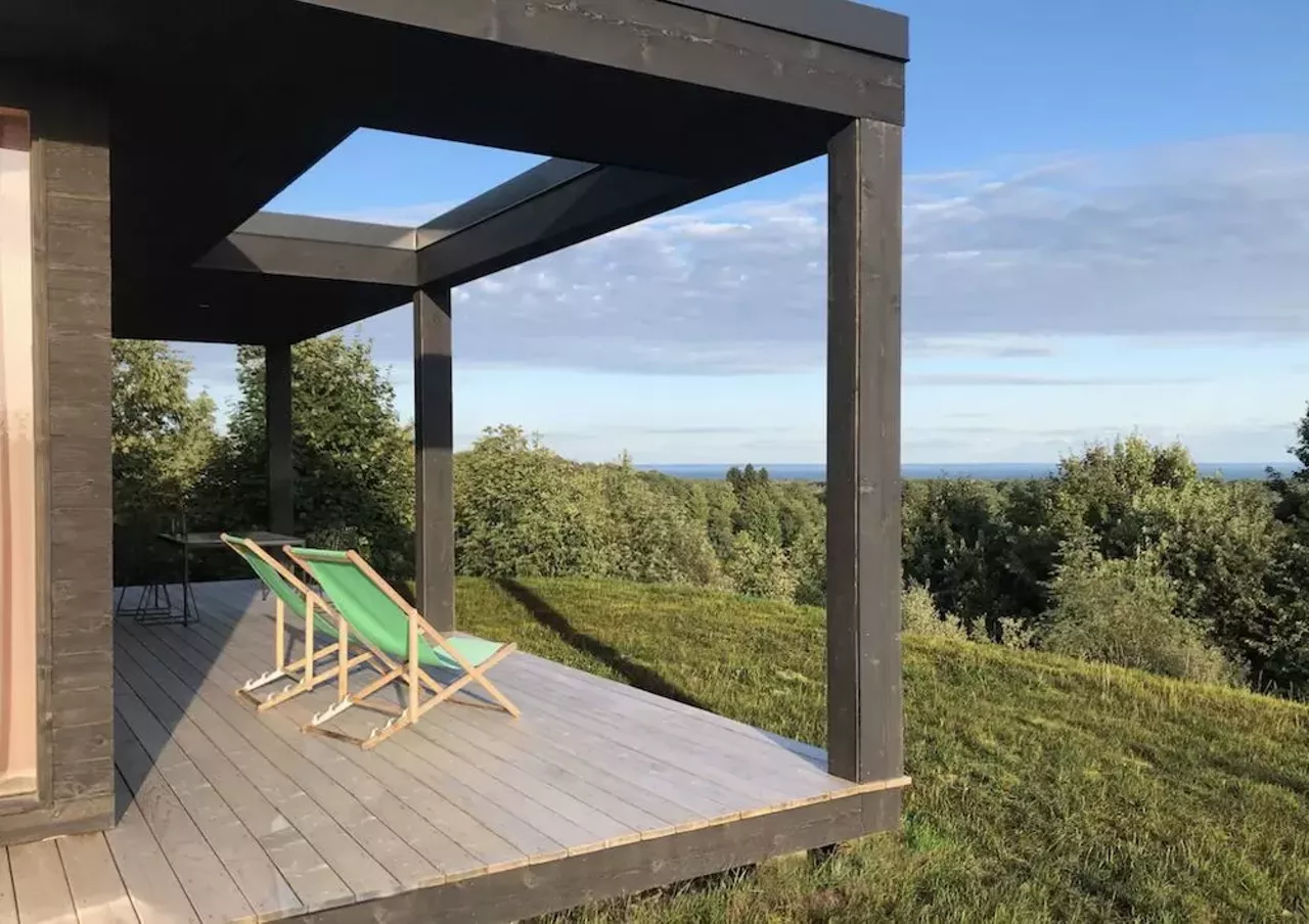Seeblick Haus in Northport 6 guests, 3 bedrooms, 3 beds, 2 baths $410 per night Get your camera ready, honey: this house is ready for its closeup. Located on a 12-acre lot, this 2019 contemporary modernist cabin in Northport offers privacy and a 270 degree view of Grand Traverse Bay and the surrounding orchards. Offering an open floor plan, the Seeblick Haus boasts floor-to-ceiling windows and sleek design touches like a rain shower, an indoor wood-burning stove, and a color scheme that looks like a goddamn delicious pack of Starbursts. Within five miles of the home, there is access to Lake Michigan beach fronts, a goat farm, vineyards, doughnuts, a small-town grocer, and ice cream. Photos via Airbnb.com