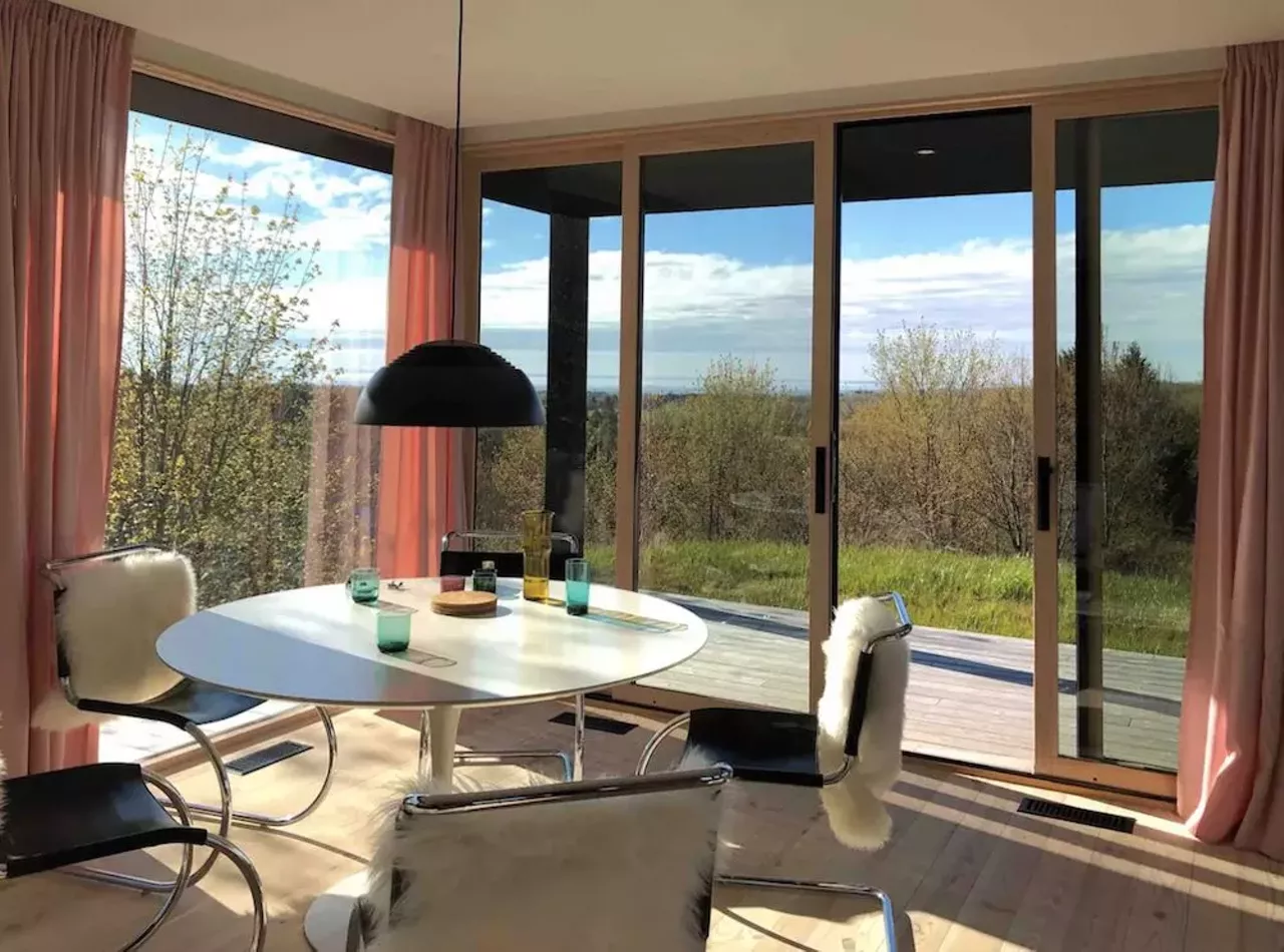 Seeblick Haus in Northport 6 guests, 3 bedrooms, 3 beds, 2 baths $410 per night Get your camera ready, honey: this house is ready for its closeup. Located on a 12-acre lot, this 2019 contemporary modernist cabin in Northport offers privacy and a 270 degree view of Grand Traverse Bay and the surrounding orchards. Offering an open floor plan, the Seeblick Haus boasts floor-to-ceiling windows and sleek design touches like a rain shower, an indoor wood-burning stove, and a color scheme that looks like a goddamn delicious pack of Starbursts. Within five miles of the home, there is access to Lake Michigan beach fronts, a goat farm, vineyards, doughnuts, a small-town grocer, and ice cream. Photos via Airbnb.com