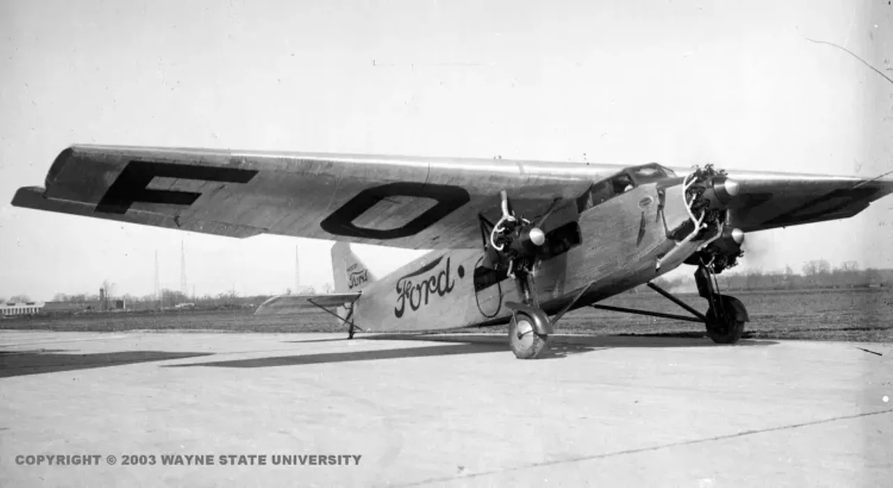 View of the Ford trimotor plane, nicknamed the Tin Goose, preparing to take off from Dearborn, Michigan carrying a Ford Touring car as its cargo. from Virtual Motor City (Photo credit: Detroit News Collection, Walter P. Reuther Library, Wayne State University)