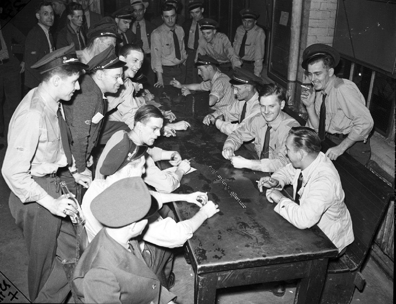 Nonetheless, the DSR&#146;s employees were as militant as any other Detroit working people during the union fever of the late 1930s and early 1940s. In this photograph from 1941, striking street railway workers &#147;gather around table to watch game of dominoes.&#148;