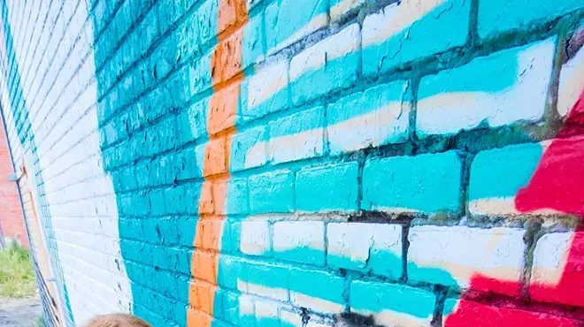 Ellen Rutt preps a wall for Murals in the Market.