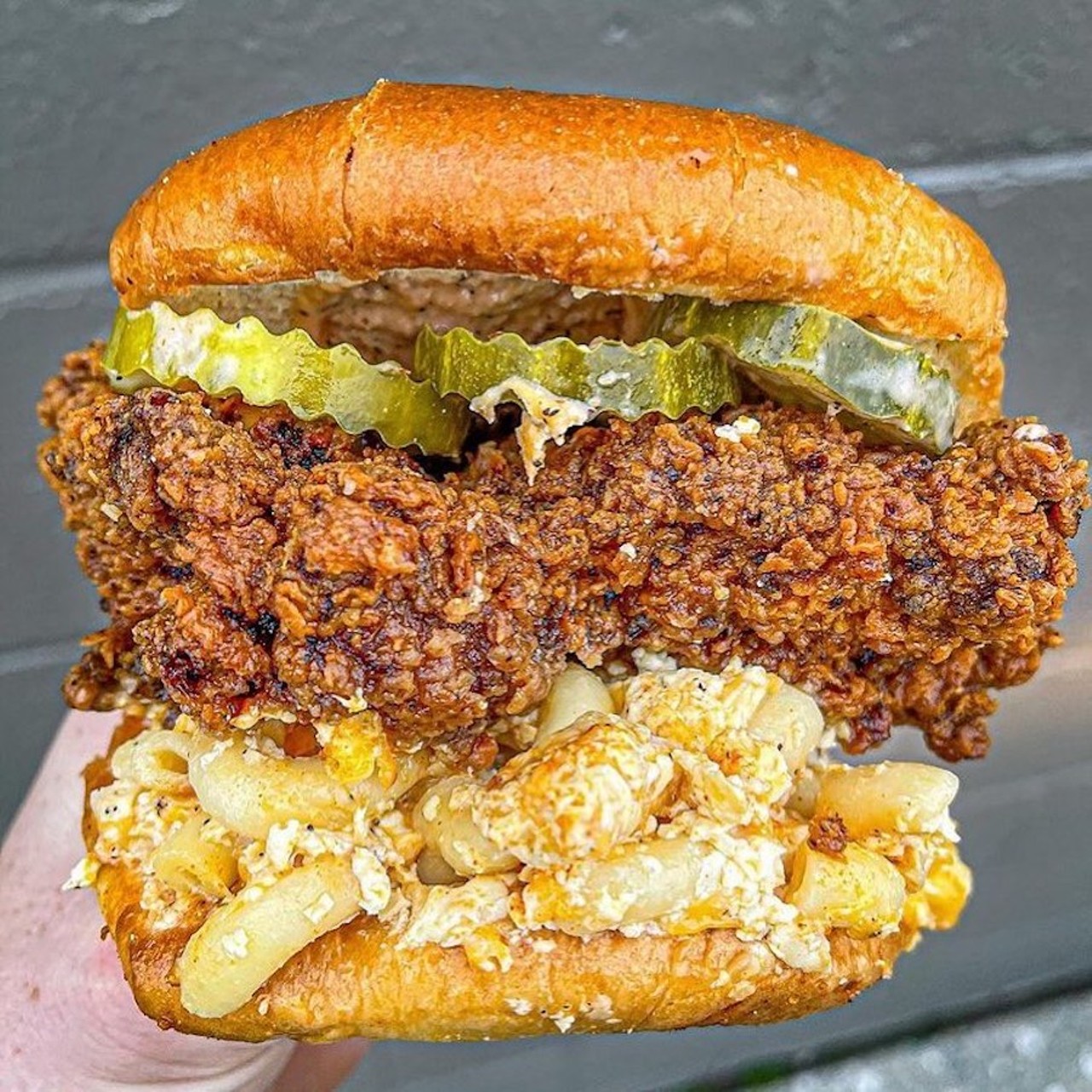 Fat Daddy's Hot Chicken and Waffles
18283 Fort St., Riverview; 734-288-3051; fatdaddys-chicken.com
Take a trip Downriver and you'll find a fried chicken sandwich being slung out of a chicken-focused carry-out shop that brings the heat and the crunch. Fat Daddy's Hot Chicken and Waffles has several sandwiches to choose from, but you can't go wrong with the original. The Fat Daddy is made with jumbo boneless chicken, comeback sauce, pickles or peppers, and served on a brioche bun and can be made in a variety of heat/spice levels. They also have the Mac Daddy, which is a chicken sandwich topped with a five-cheese mac and cheese, because why the hell not? While we're throwing inhibitions to the wind, try the Suga Mama, which is a spicy, honey-drenched chicken sandwich with donuts for buns. We have three words: bring it on. 
Photo via Fat Daddy's Hot Chicken and Waffls/Facebook