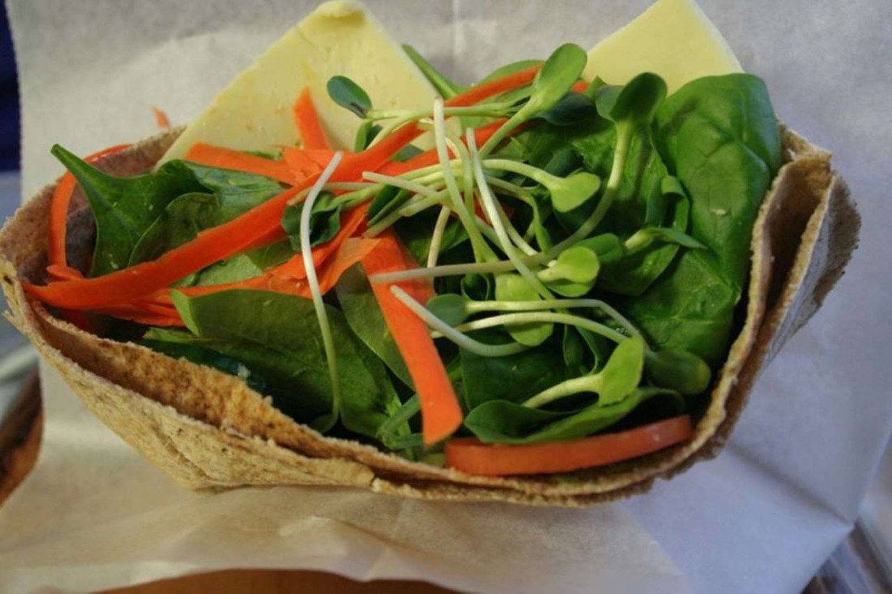 The &#147;Pocket Sandwich&#148; from Goodwell's Natural Foods Market
Before it became the now-shuttered Alley Taco, the space next to Avalon International Breads along the Cass Corridor belonged to Goodwell's Natural Foods Market, home of the gone, but never forgotten, pocket sandwich. Goodwell's, a Black-owned business, offered budget-friendly healthy and organic food choices at a time when the city maintained a reputation as a food desert. While there were many fan favorites at Goodwell's, it is the &#147;Famous Pocket Sandwich&#148; that continues to stand above the rest, even after Goodwell's closed in 2016. The simple whole wheat pita pocket, filled with a vegetarian soy patty topped with baby spinach, romaine, tomatoes, cucumbers, alfalfa sprouts, and Goodwell's secret sauce, was just $4.25. 
Photo via  Yelp!/Lynn S. 