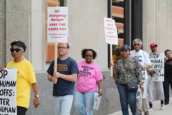 A coalition of activists protests outside the Detroit Water & Sewerage Department’s office in downtown Detroit on Friday, June 6, 2014. - RYAN FELTON/MT