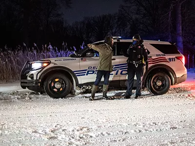 Detroit Sugarbush Project organizer Antonio Cosme speaking with police on Friday, Feb. 18.