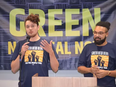 Saul Levin, Green New Deal Network legislative and policy director, (pictured on the left) addressed those who attended Sunday’s “Green New Deal for Michigan” rally in Dearborn. Mikal Goodman, campaign manager at Michigan Alliance for Justice in Climate, is shown on the right.