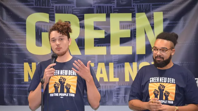 Saul Levin, Green New Deal Network legislative and policy director, (pictured on the left) addressed those who attended Sunday’s “Green New Deal for Michigan” rally in Dearborn. Mikal Goodman, campaign manager at Michigan Alliance for Justice in Climate, is shown on the right.