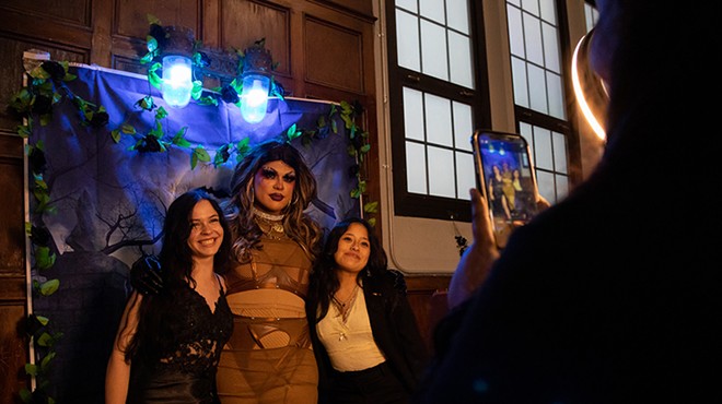 Queer prom attendees pose with drag performer Jezebel’s Inferno.