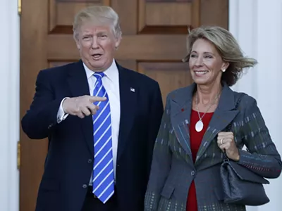 Betsy DeVos and former President Donald Trump.