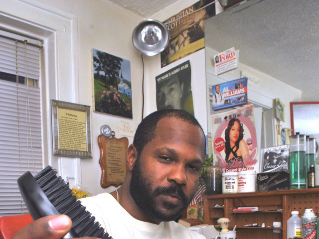 Robert Watson with his brushes in his home barbershop.